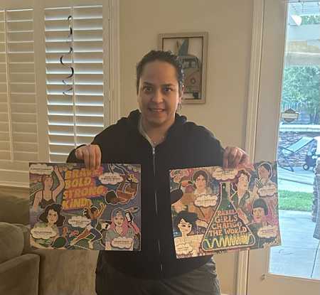 Alyssa holding finished puzzles