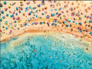 Aerial View of Sandy Beach with Colorful Umbrellas